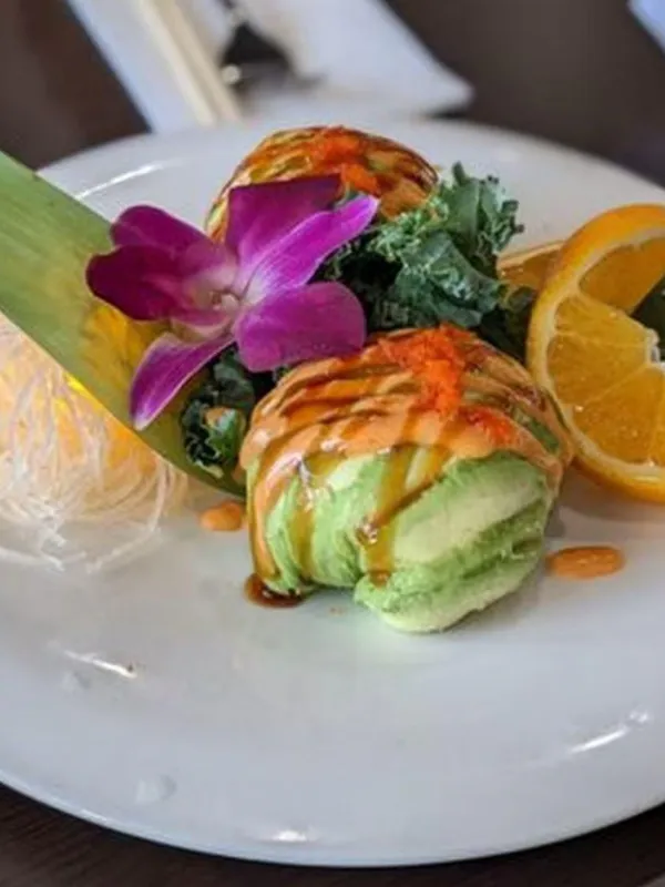 Avocado seafood sushi roll with sauce at Mirai Sushi & Thai, a Sushi Restaurant in Lucie
