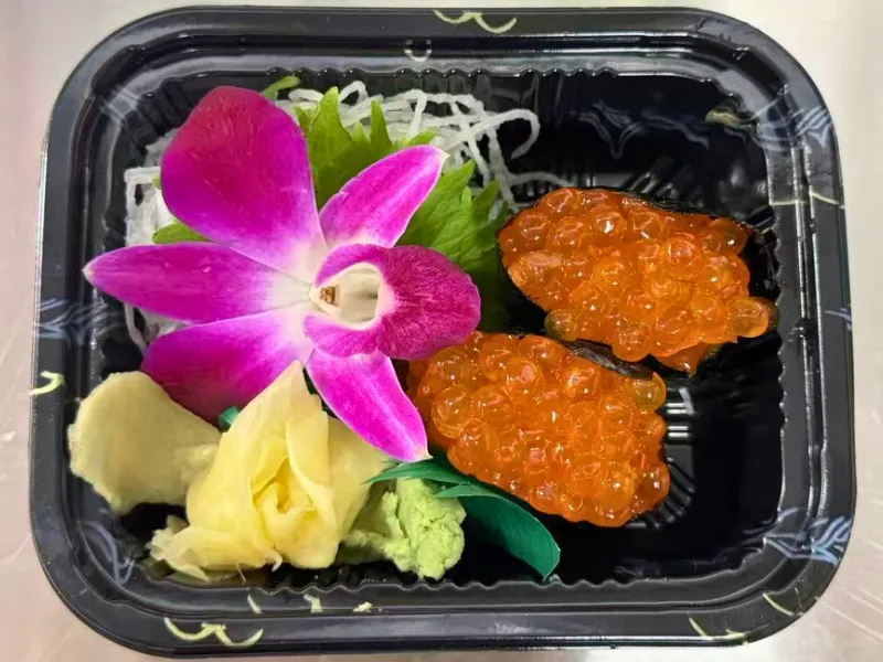 Two salmon roe nigiri in takeout box at Mirai Sushi & Thai, a Sushi Restaurant in Lucie
